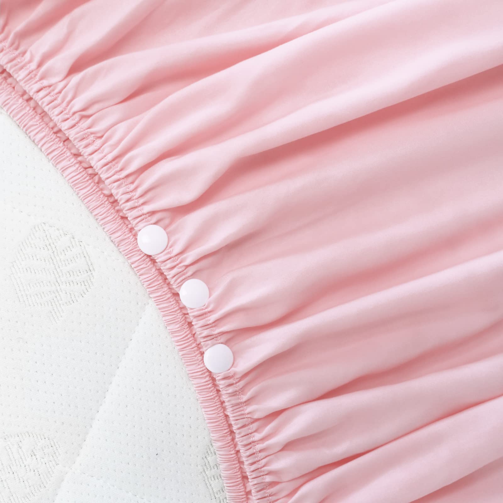 Biloban crib skirt close-up shows pleated pink dust-ruffle fabric detail.