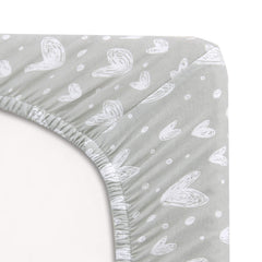 Two-pack jersey cotton fitted sheets stay snug on a playard mattress.
