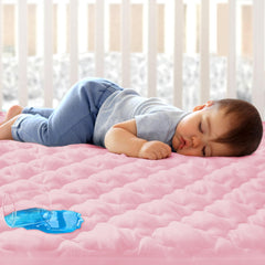 Biloban mini crib protector pink, front view, soft quilted surface protecting the mattress