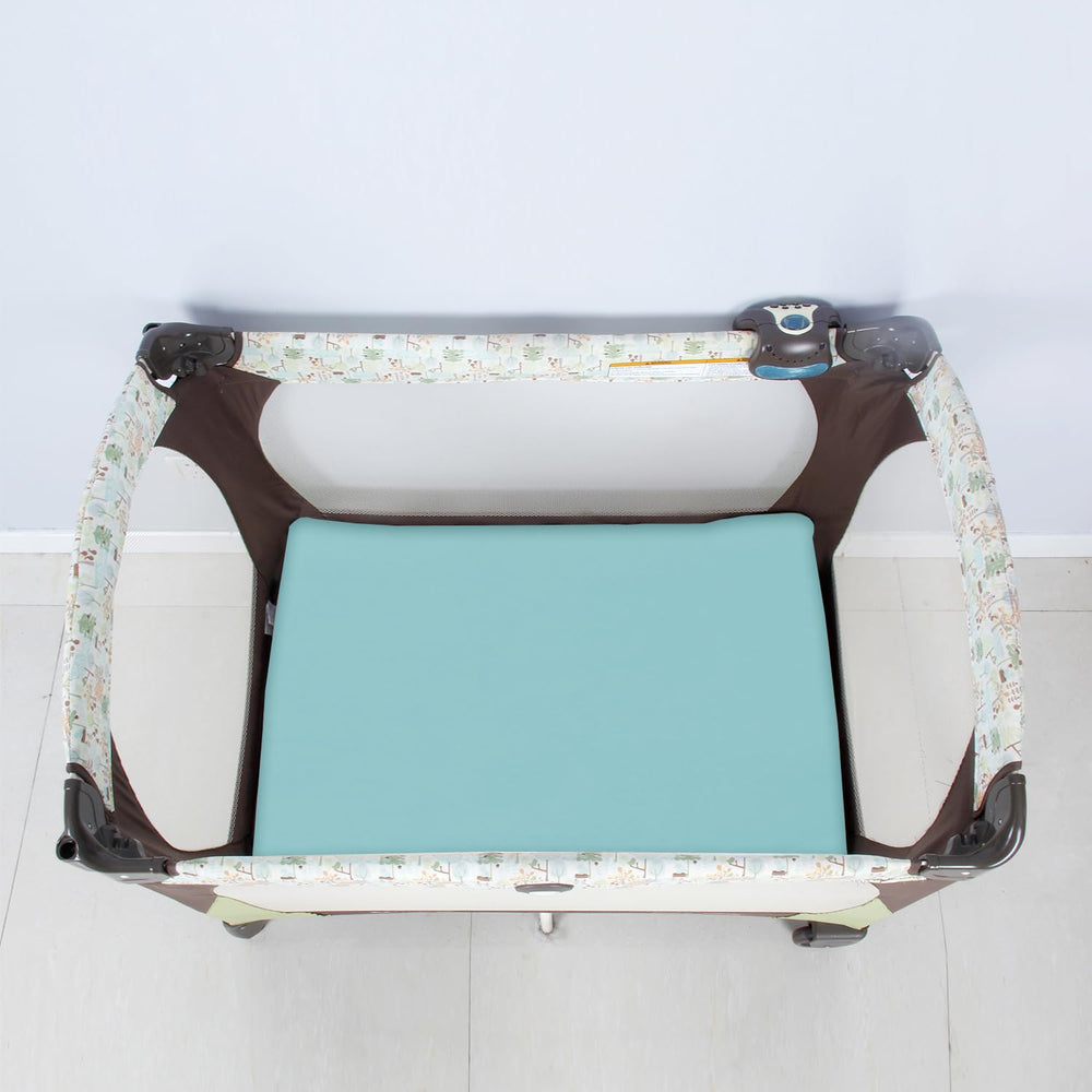 Biloban elastic-edge fitted sheet on a Graco playard for a flat sleep surface