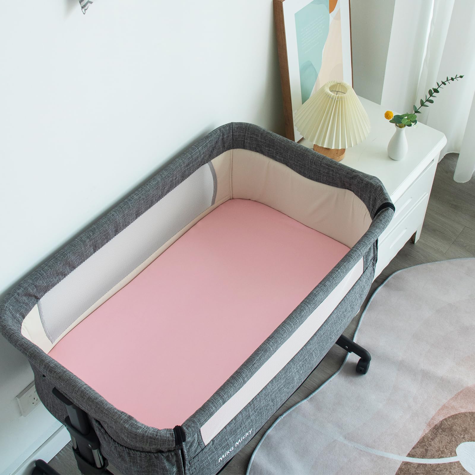 Pink print Biloban sheets add a gentle, soothing nursery look.