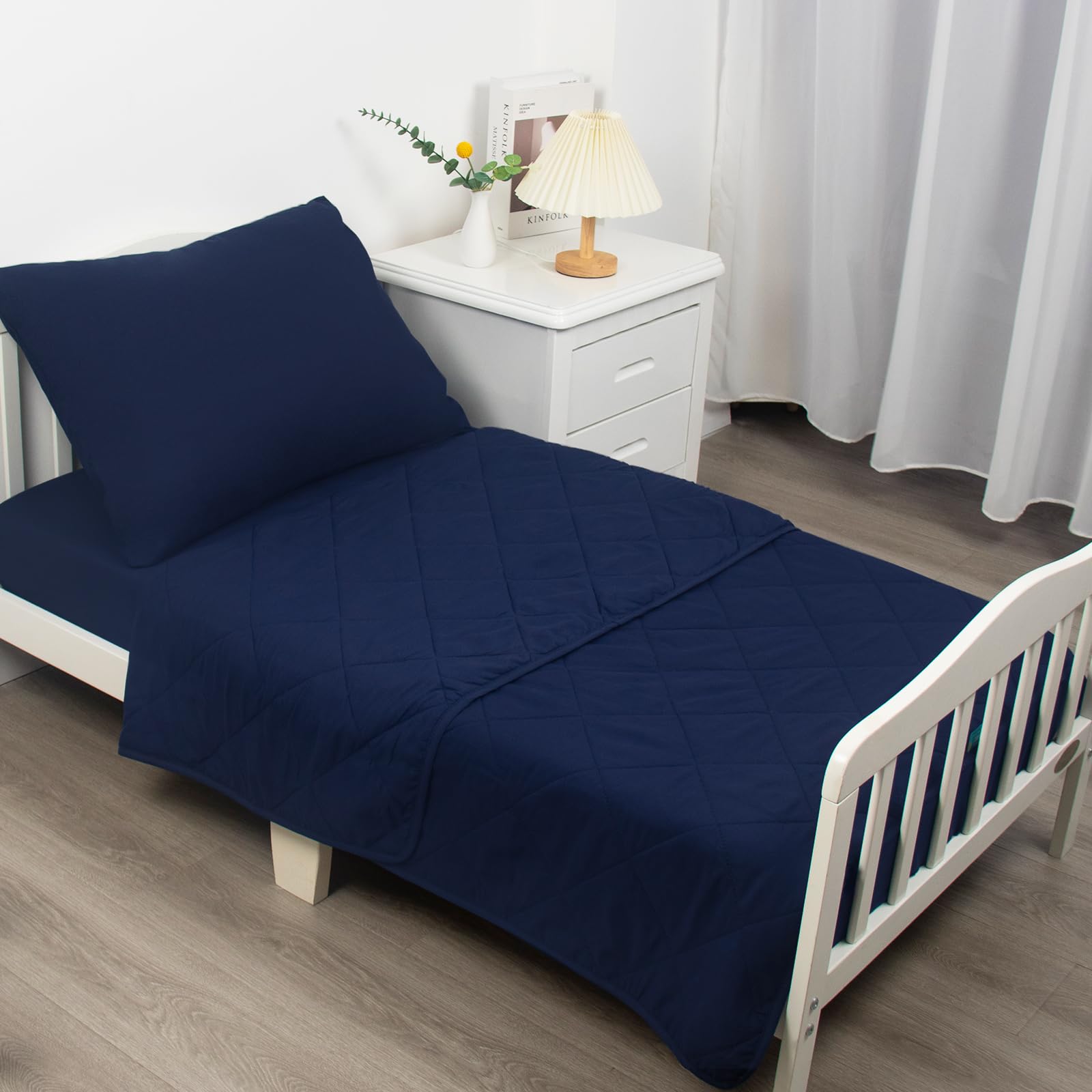 Biloban fitted sheet on standard toddler bed demonstrates secure fit