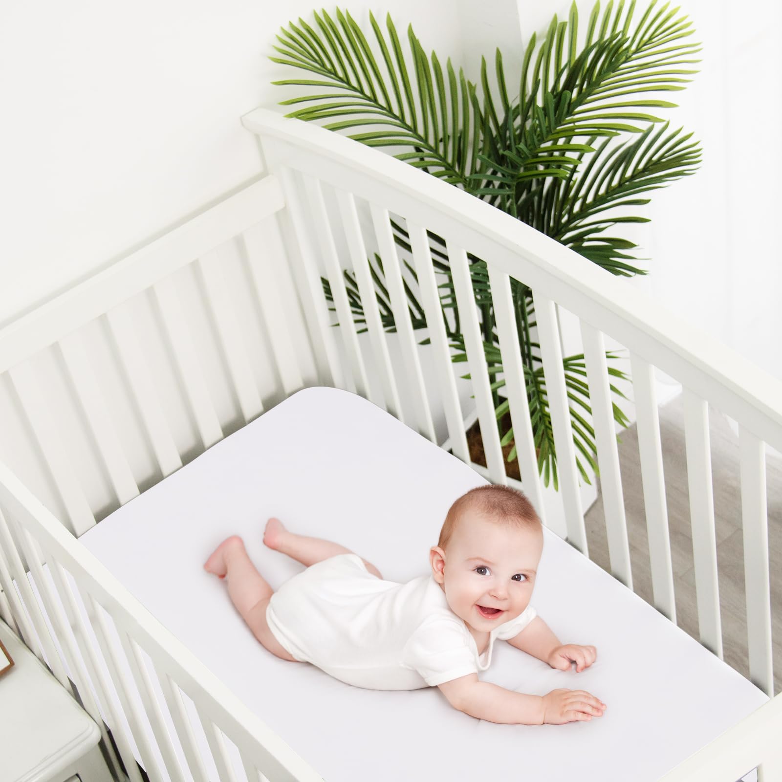 Biloban white crib sheets in a calm baby bedroom setup