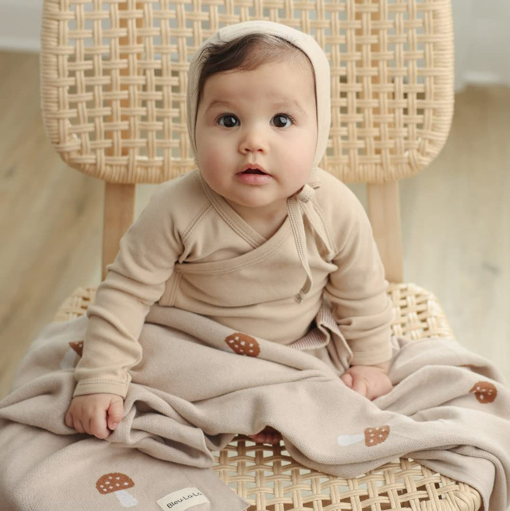Bleu La La nursery decor neutral blanket adds cozy styling and cuddle option