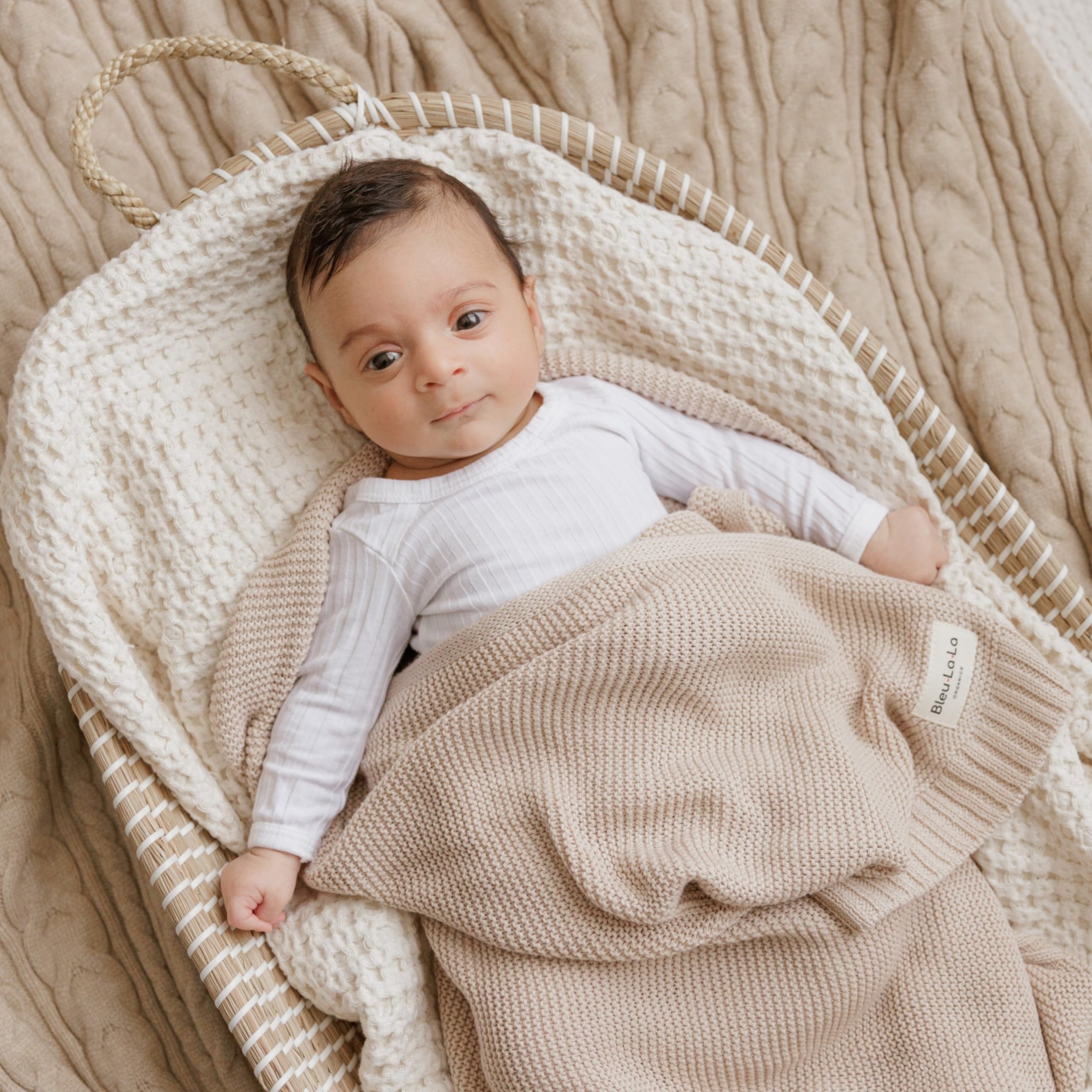 Gift-ready Bleu La La blanket with monogrammed ribbon for welcoming newborns.