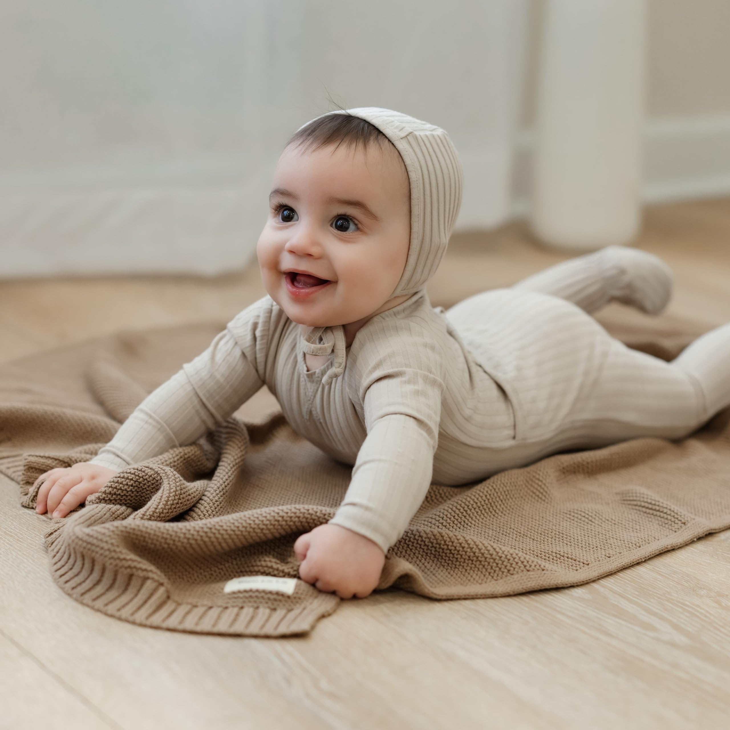 Bleu La La Heritage Knit car-seat wrap providing gentle warmth during rides.
