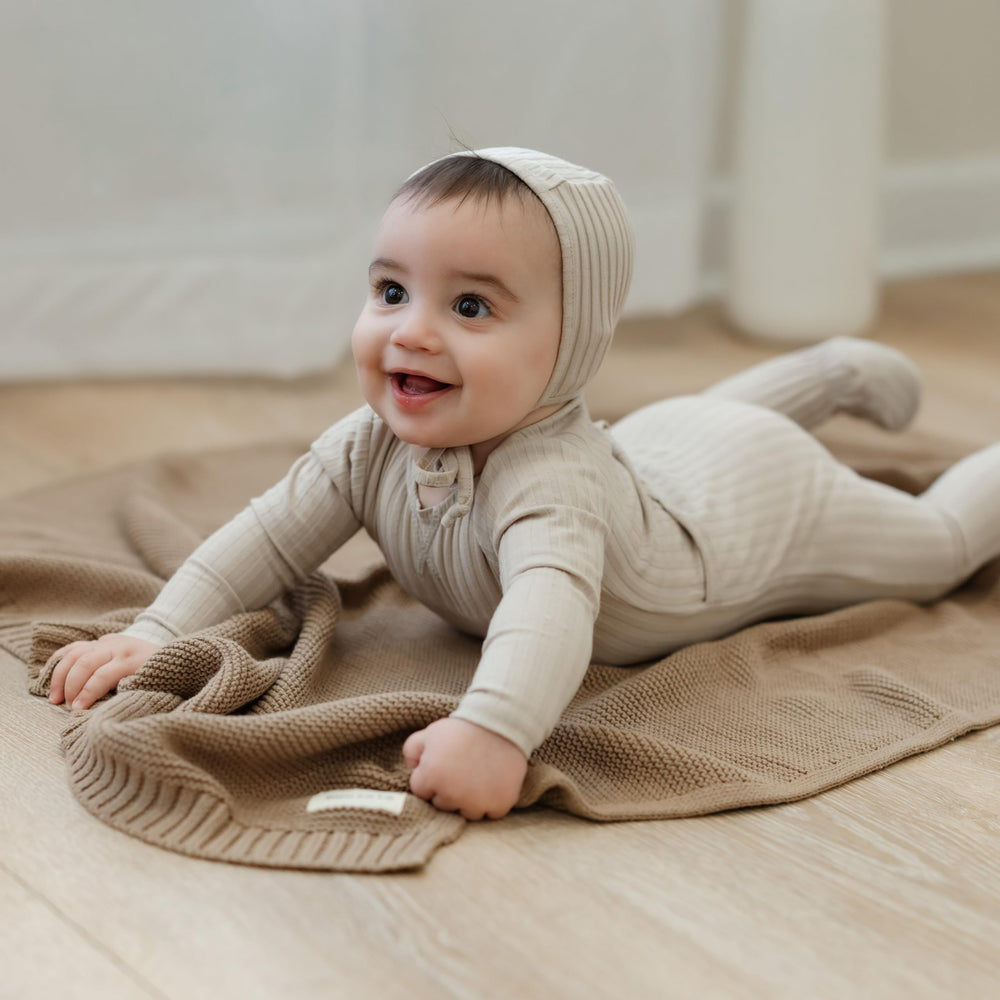 Bleu La La Heritage Knit car-seat wrap providing gentle warmth during rides.