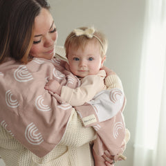 Bleu La La Knit Baby Swaddle Rainbow Pink folded in nursery conveys versatile all-season comfort.