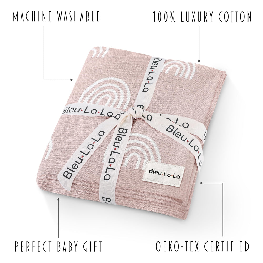 Bleu La La Knit Baby Swaddle Rainbow Pink swaddled in arm demonstrates secure, cozy snug.