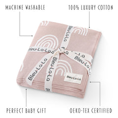 Bleu La La Knit Baby Swaddle Rainbow Pink swaddled in arm demonstrates secure, cozy snug.