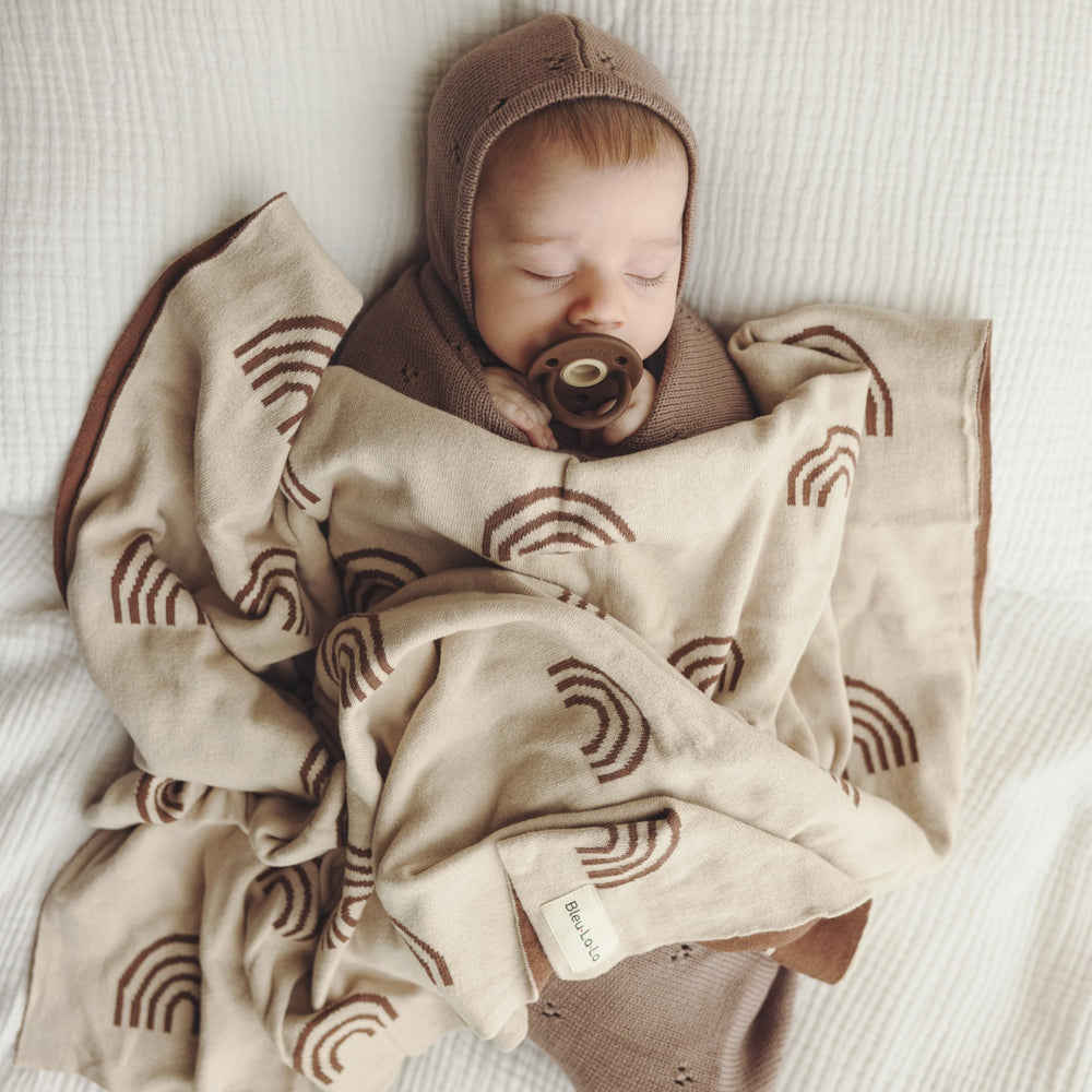Bleu La La rainbow taupe blanket in car seat for soft travel warmth