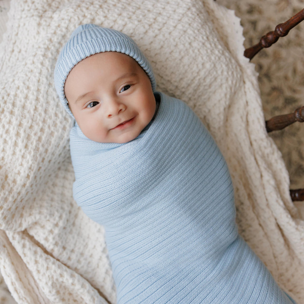 Bleu La La Soft Cotton Knit Swaddle showing stretch for secure wrapping