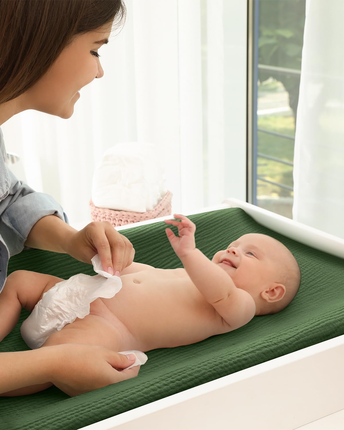 Blissful Diary changing pad on a bassinet setup demonstrating the 5-inch pocket depth.
