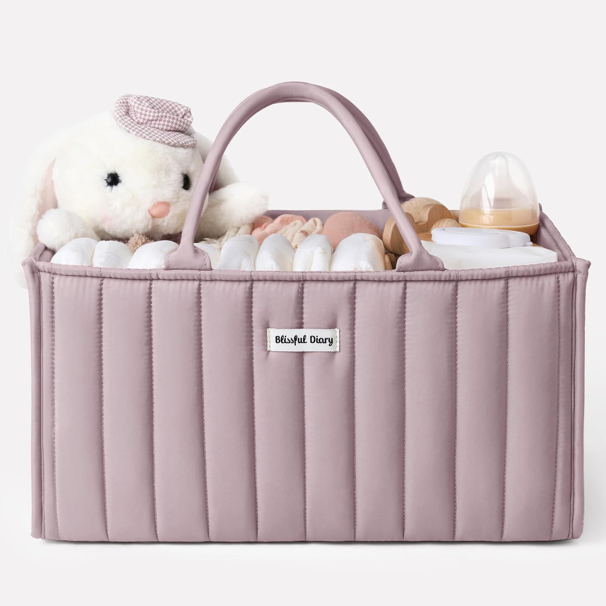 Blissful Diary diaper caddy with mauve pink handles for easy room-to-room transport.