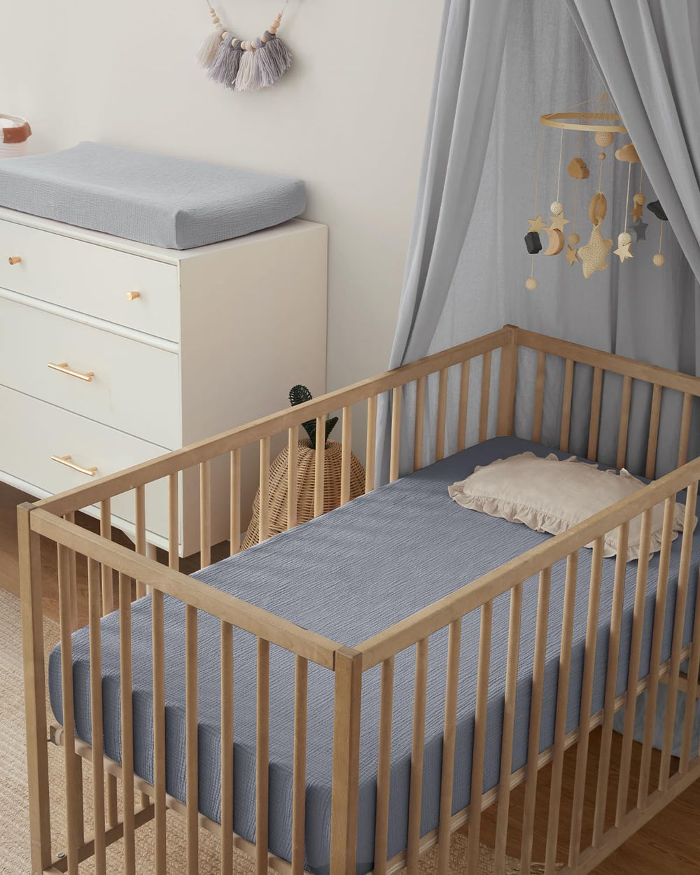 Blissful Diary boho neutral nursery decor with coordinated crib sheets.