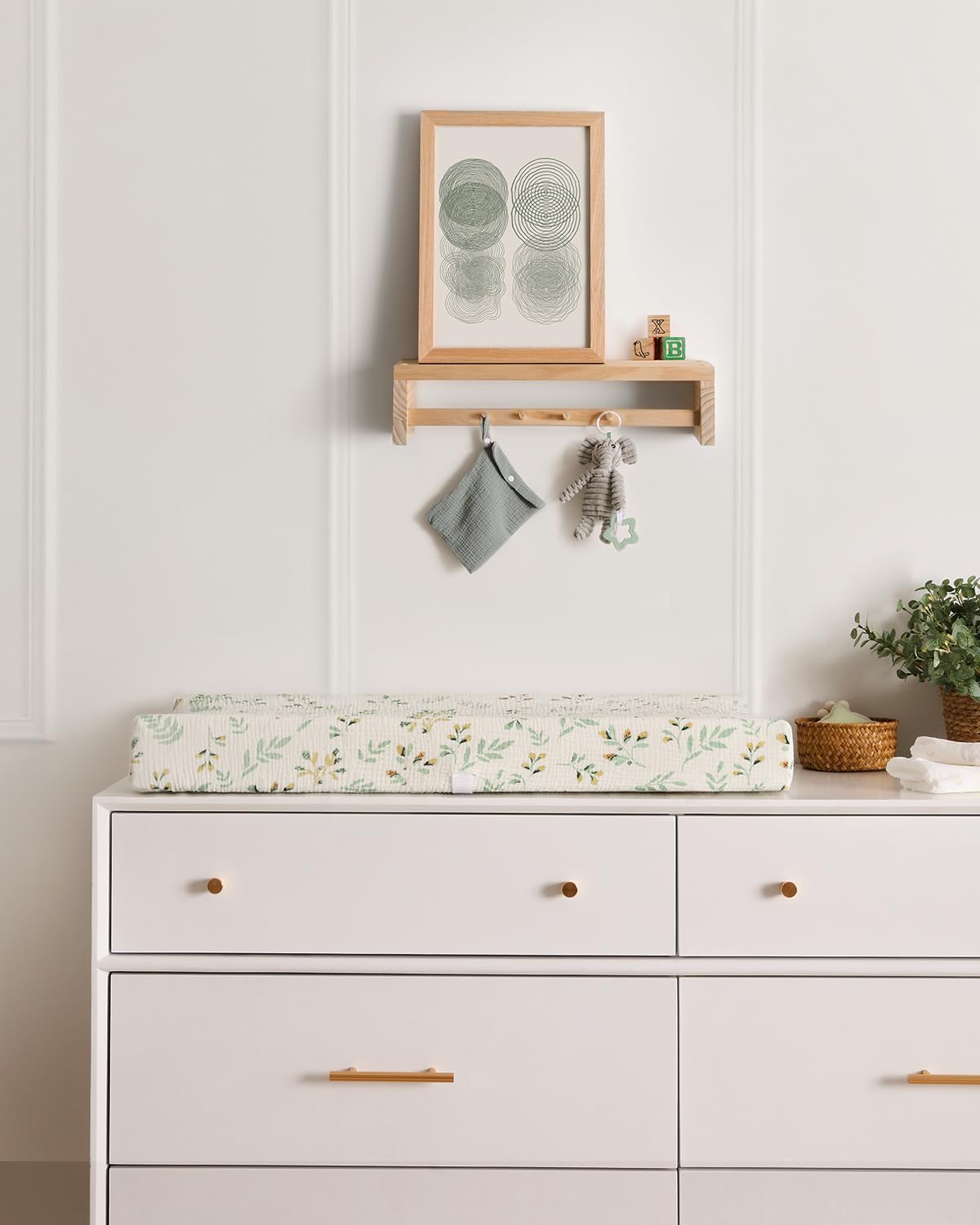 Blissful Diary nursery setup with a tidy changing area using leaf prints.