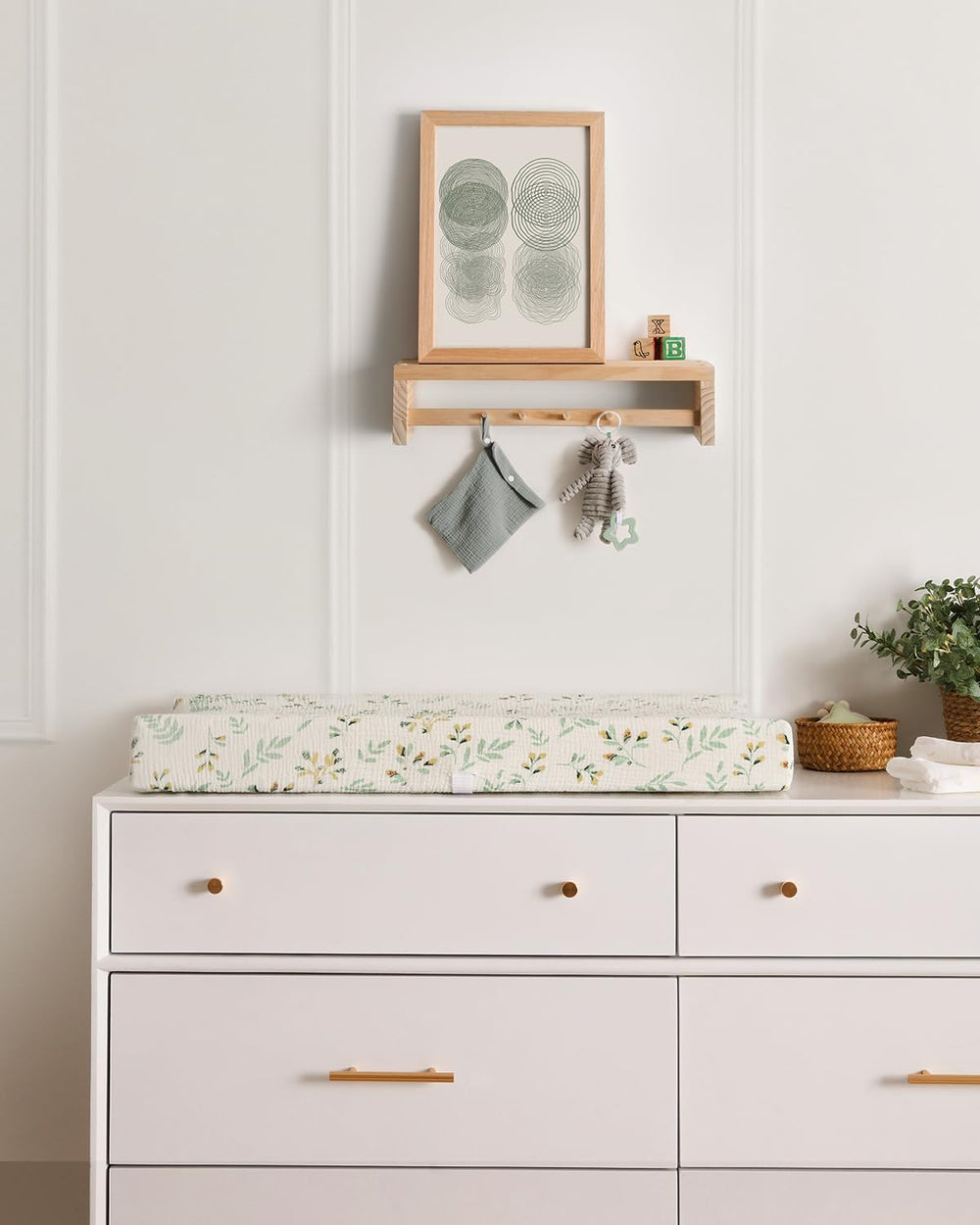 Blissful Diary nursery setup with a tidy changing area using leaf prints.