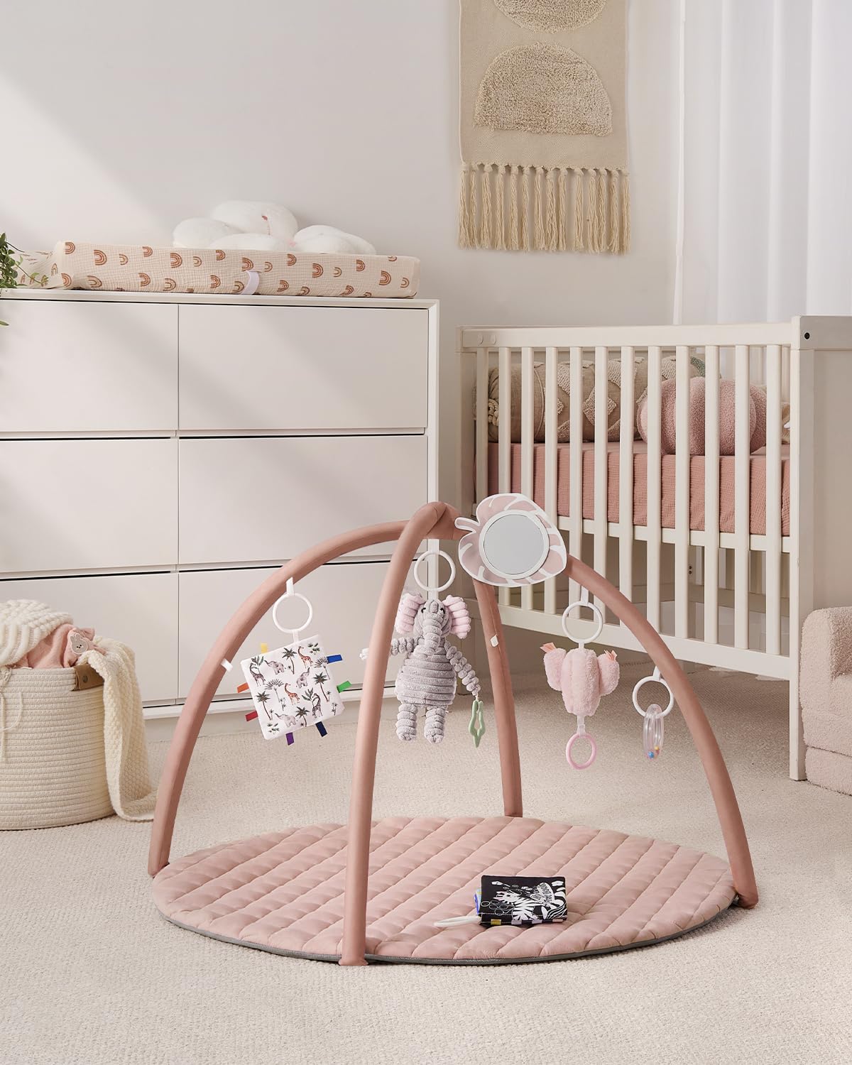 Detachable toys on Blissful Diary gym mat to engage senses during play.