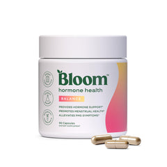 Bloom Nutrition Hormone Health bottle pouring capsules for daily balance support.