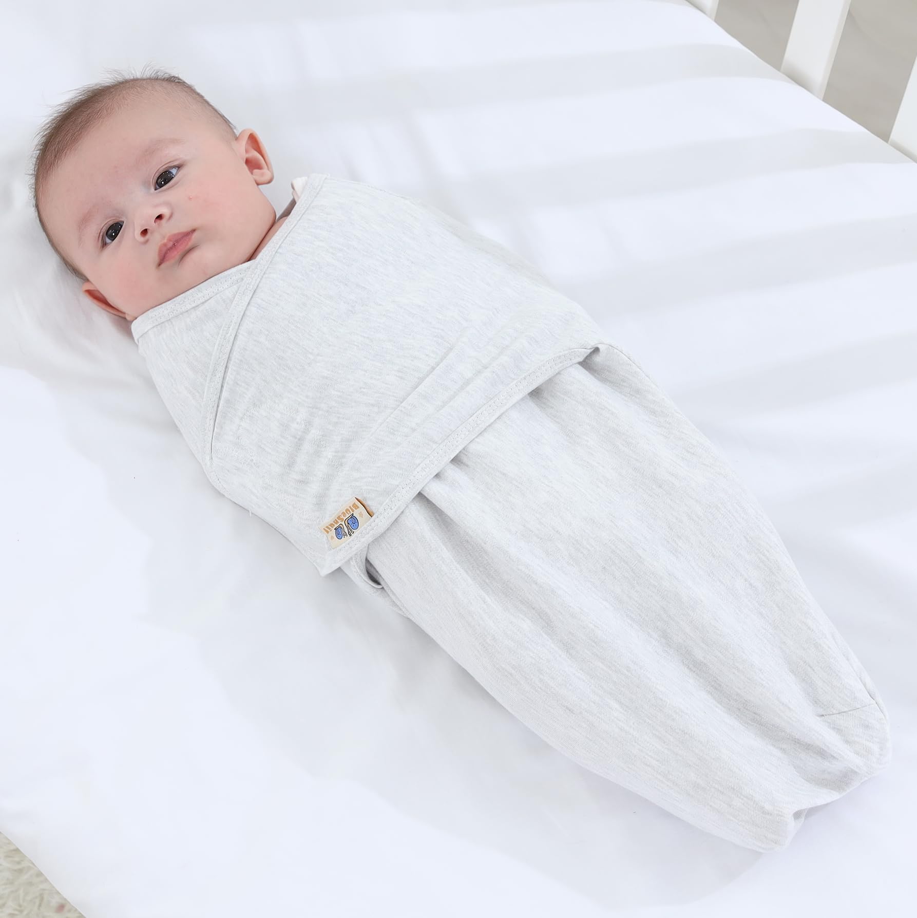 BlueSnail swaddle with adjustable closure demonstrates easy, secure fit for soothing newborns