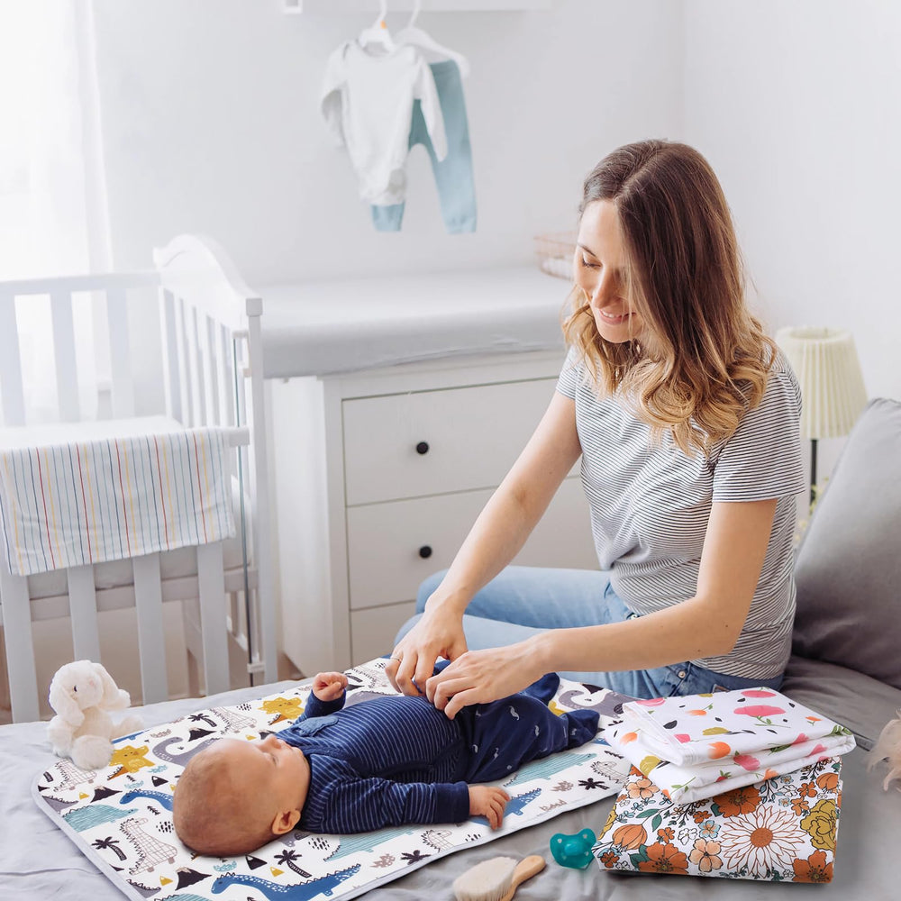 Bnditeu portable changing pad in travel-ready design with purple flowers.