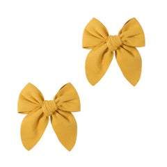 Boenbe Loved yellow satin bow clip from the front view, stylish everyday accessory for toddlers.