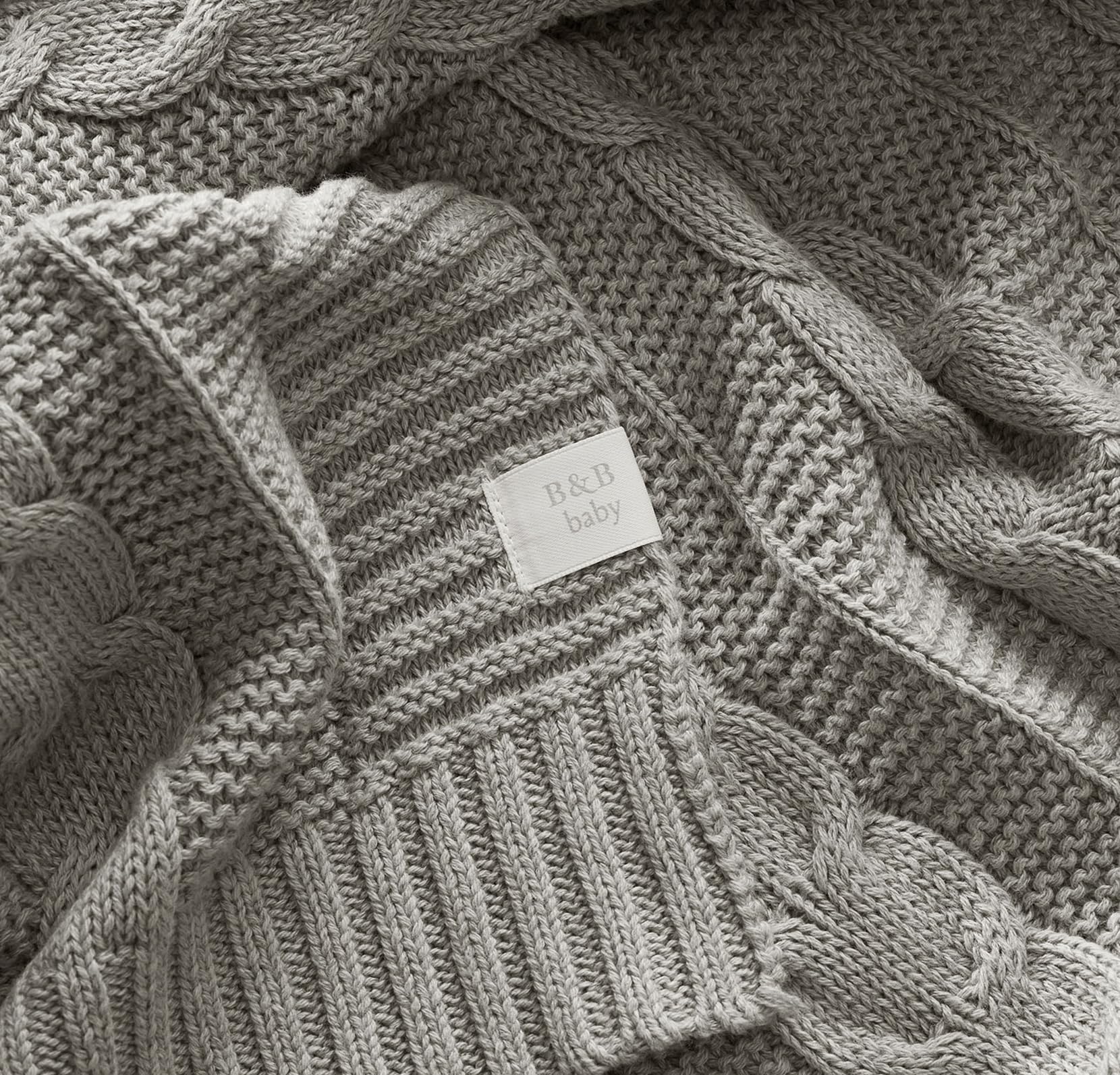 Boll & Branch machine-washable baby blanket draped for easy care after messes