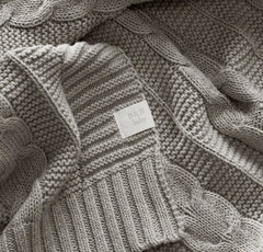 Boll & Branch machine-washable baby blanket draped for easy care after messes