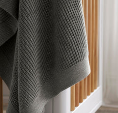 Boll & Branch ribbed knit blanket demonstrates growth-friendly size as baby ages.