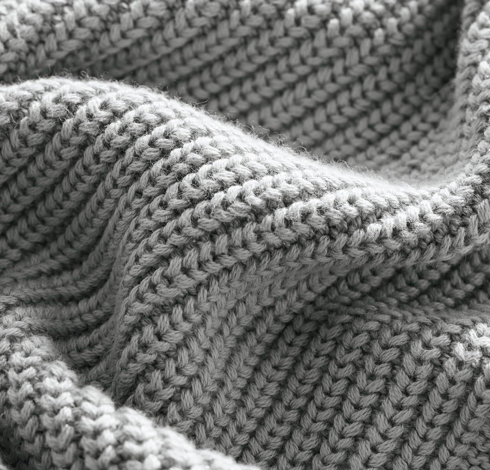BOLL & BRANCH ribbed knit baby blanket Shore close-up reveals breathable fibers and fine texture.
