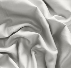 Boll & Branch Signature crib sheet on mattress demonstrates secure, snug fit
