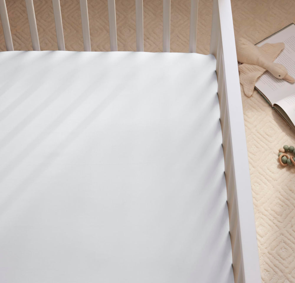 Boll & Branch Signature crib sheet close-up of 100% organic cotton softness in sky