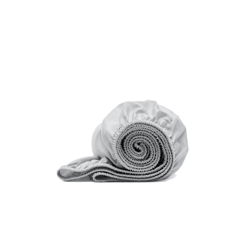 Boll & Branch Signature hemmed fitted crib sheet in sky showing soft fabric weave for baby comfort