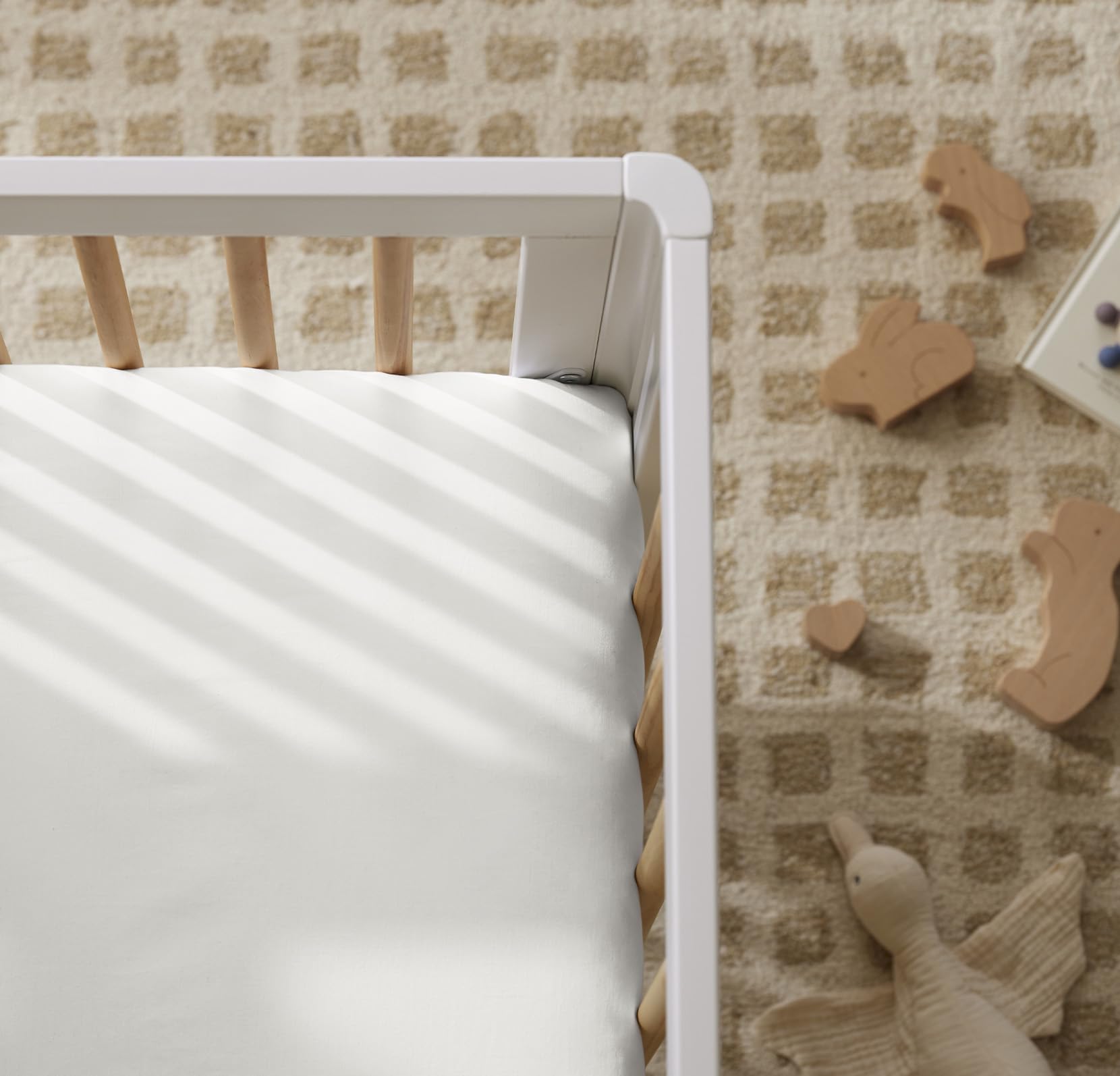 Boll and Branch crib sheet with top-stitched elastic band for snug fit.