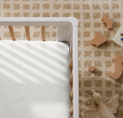 Boll and Branch crib sheet with top-stitched elastic band for snug fit.