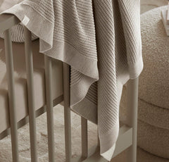 Boll & Branch blanket used in toddler bed setting for growth.
