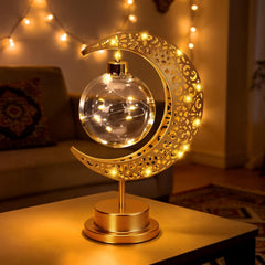 BomKra Crescent Moon Table Lamp in gold with glass shade for warm bedroom ambiance.