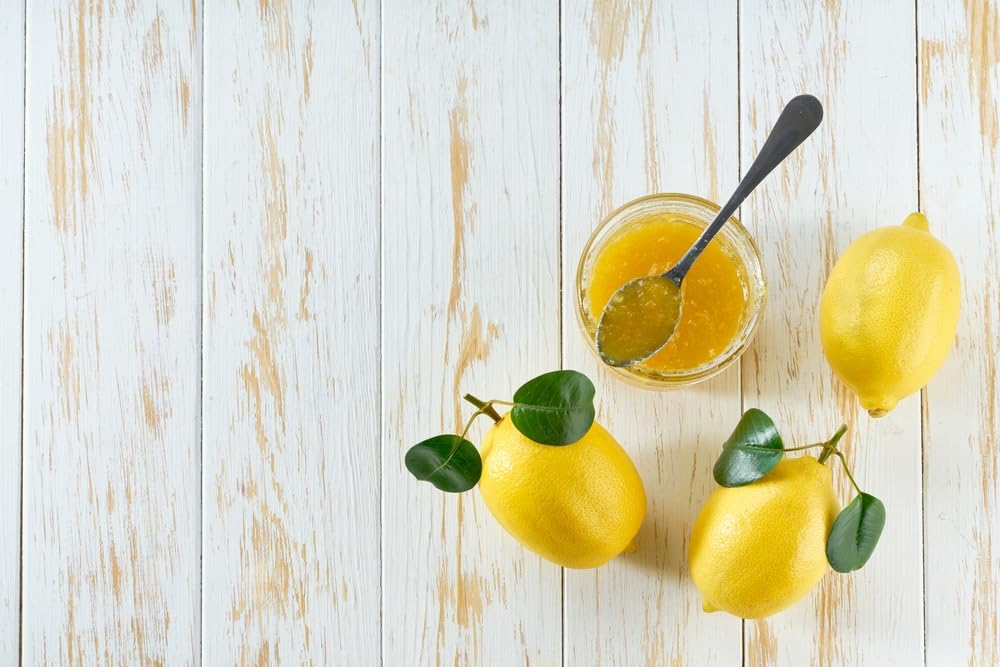 Bono marmalade bottle on kitchen counter with fresh lemons nearby.
