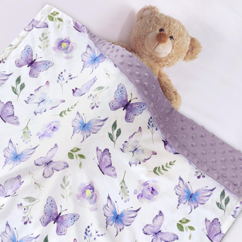 BORITAR blanket shows purple butterfly pattern adding cheerful color to the nursery