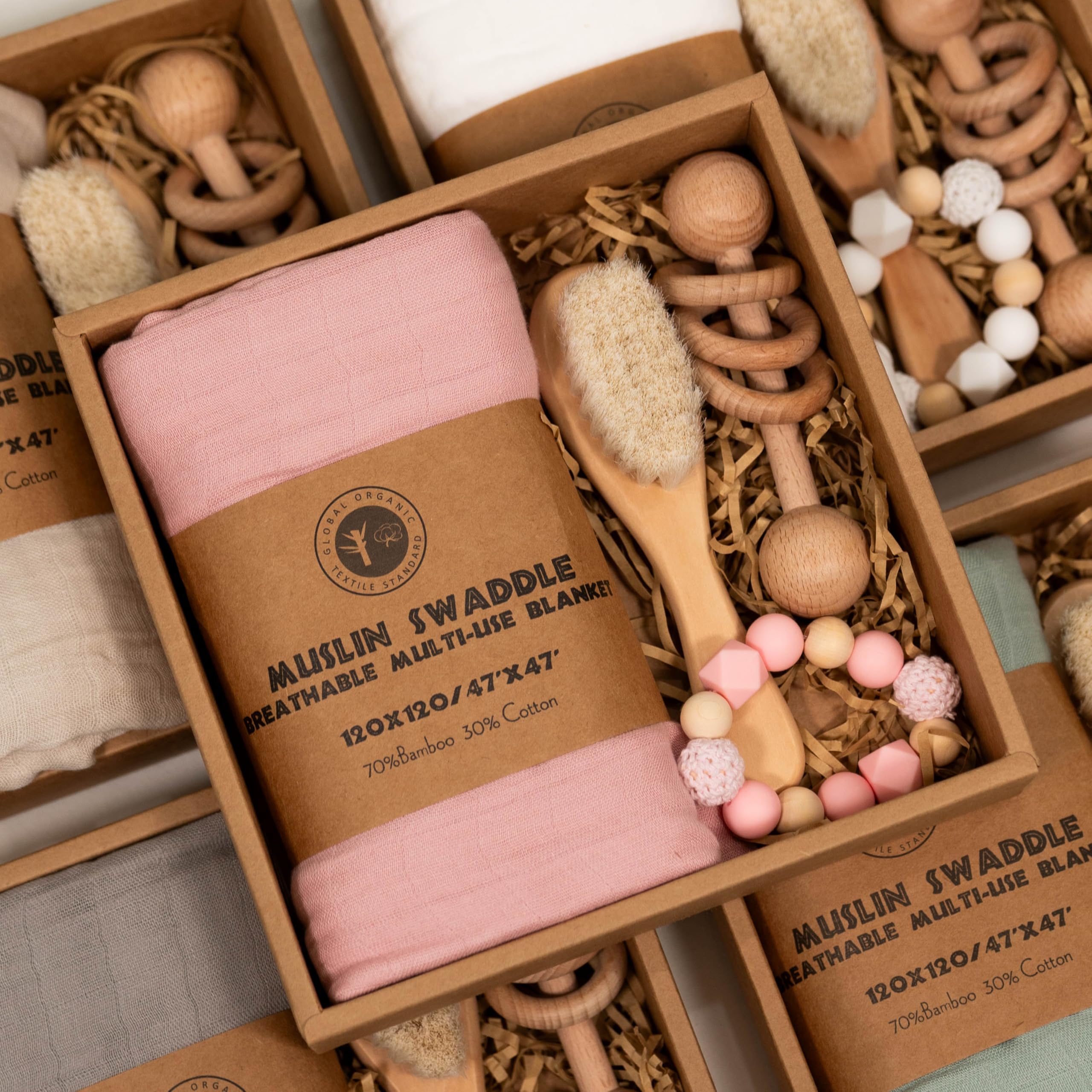 BoxLux newborn gift box features a wooden rattle for early sensory play