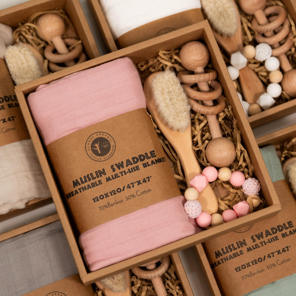 BoxLux newborn gift box features a wooden rattle for early sensory play