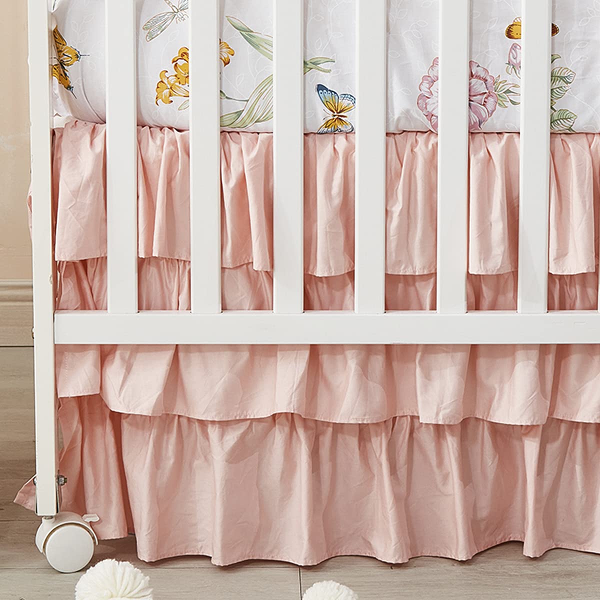 Brandream blush pink crib skirt with ruffles for a charming four-sided fit around a standard crib.