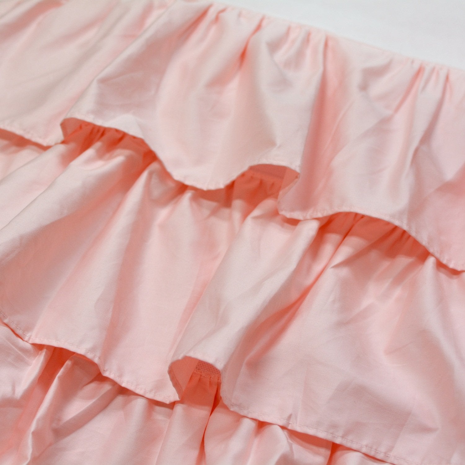 Brandream blush pink triple-layer crib skirt adds depth and cozy feel to nursery.