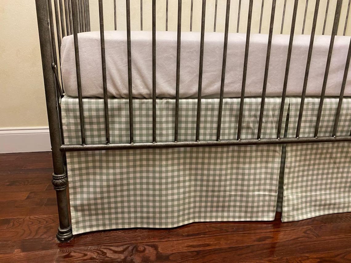 Brandream crib skirt in sage green gingham adds timeless charm to a nursery.