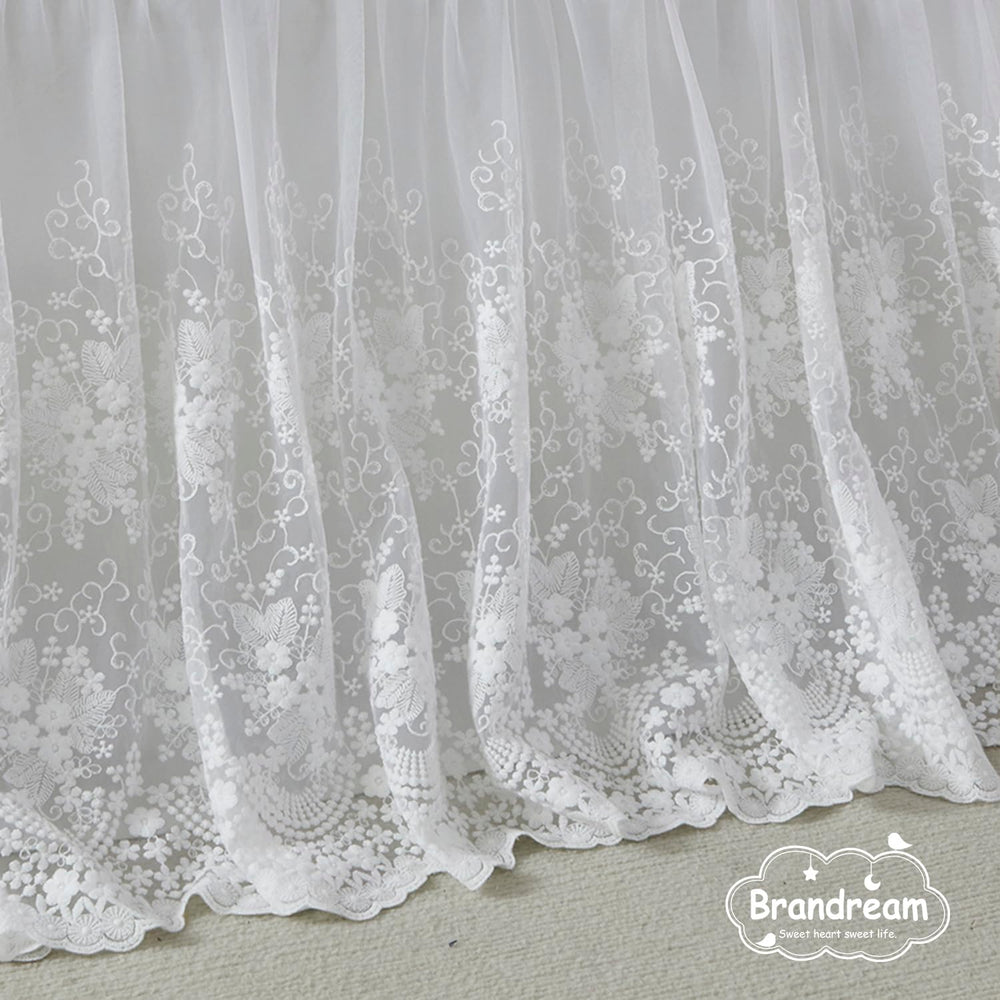 Brandream four sided crib skirt drops 16 inches for a snug fit.