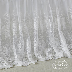 Brandream four sided crib skirt drops 16 inches for a snug fit.