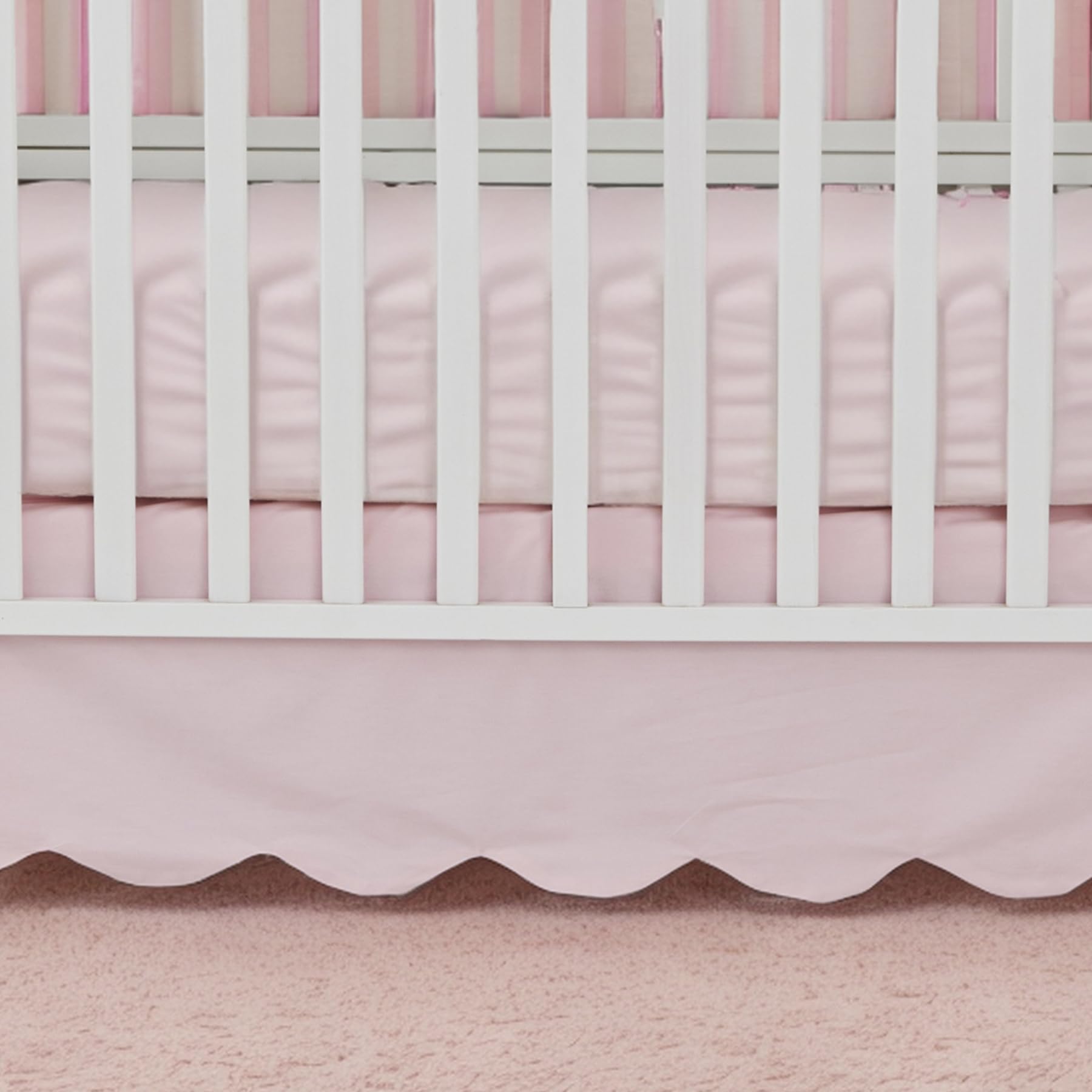 Brandream scallop edge crib skirt draped on crib highlights elegant design for coordinated nurseries.