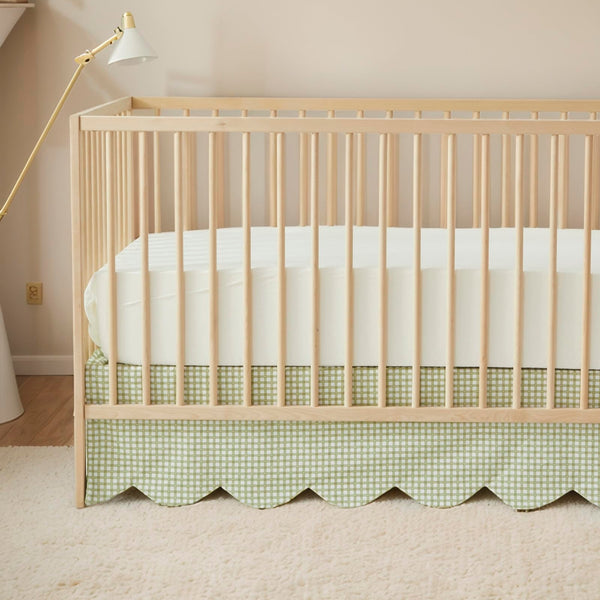Brandream scallop-edge crib skirt in green gingham adds elegant nursery detail.