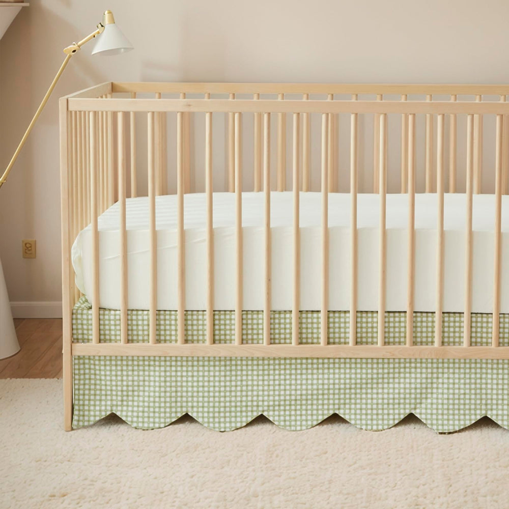 Brandream scallop-edge crib skirt in green gingham adds elegant nursery detail.