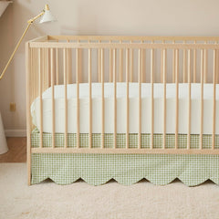 Brandream scallop-edge crib skirt in green gingham adds elegant nursery detail.